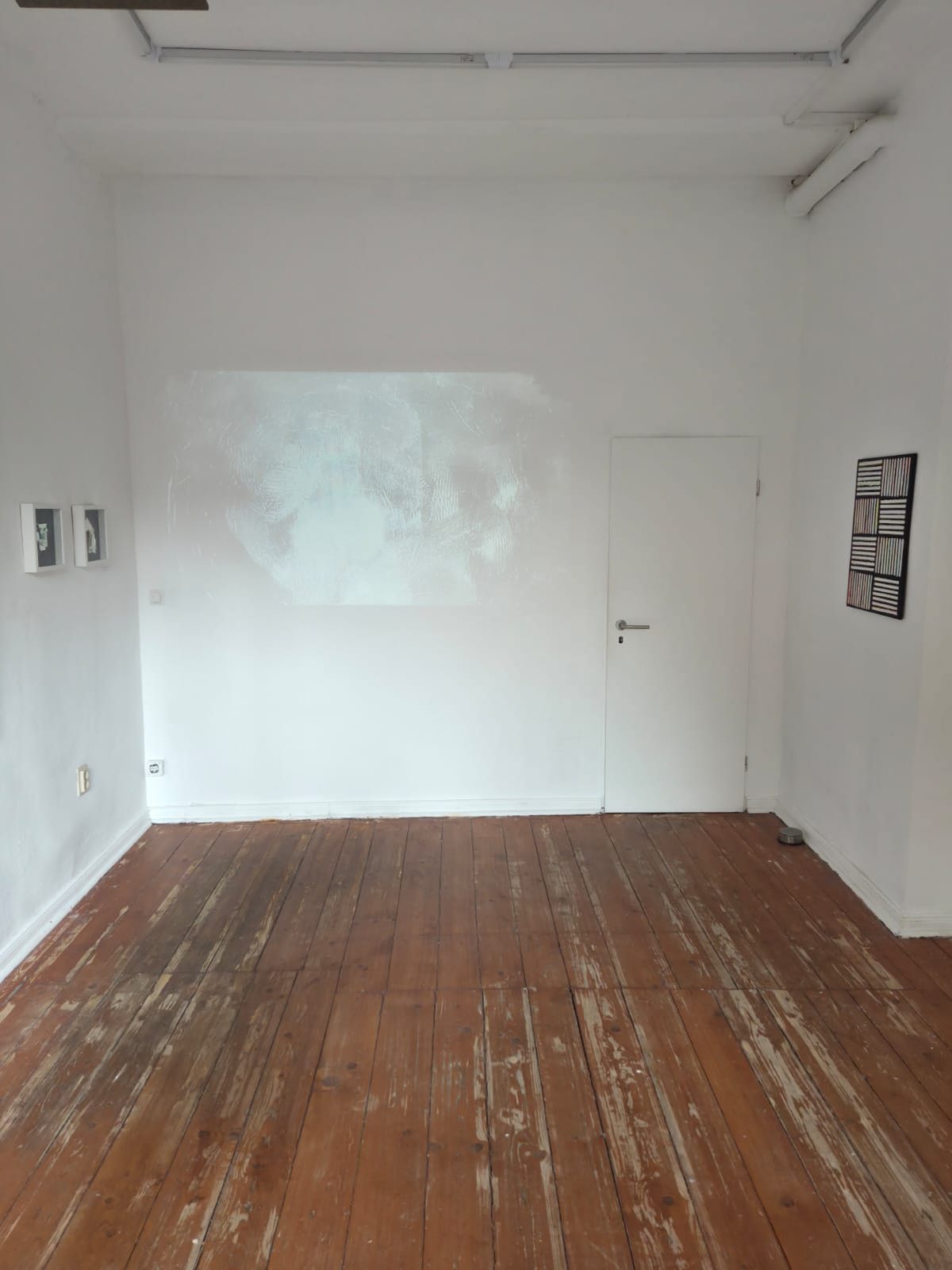 Galerieraum mit Videoprojektion an der Stirnwand